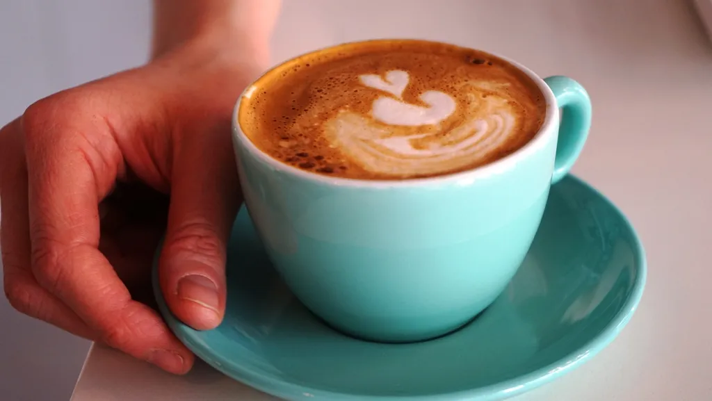 A latte in a teal cup